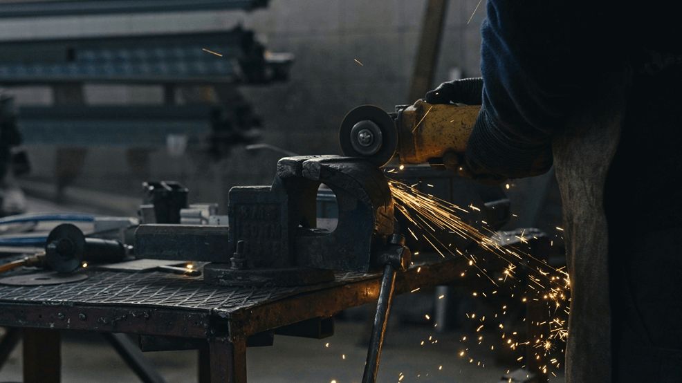 Professional welder in workshop demonstrating proper welding equipment use